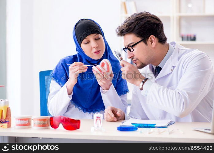 Dentist doctor and assistant working on new tooth implant