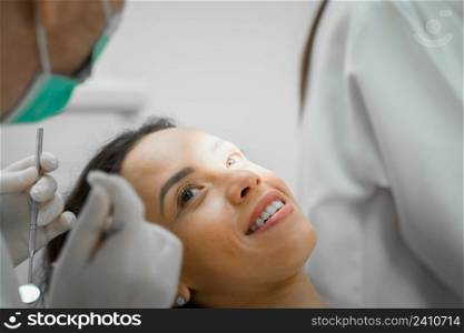 Dentist doing a dental treatment,Dentist using dental equipment for examination of teeth of a female patient.