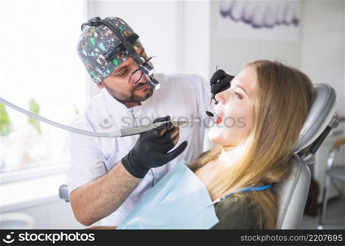 dentist doing dental treatment female patient