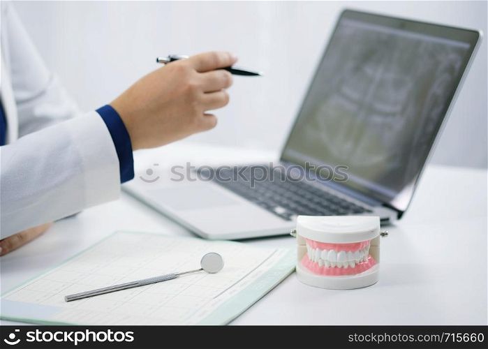 Dentist examining a patient teeth medical treatment at the dental office.