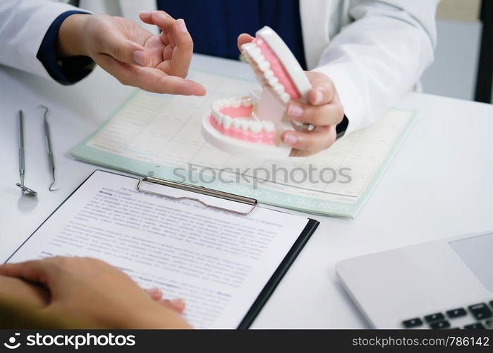 Dentist examining a patient teeth medical treatment at the dental office.