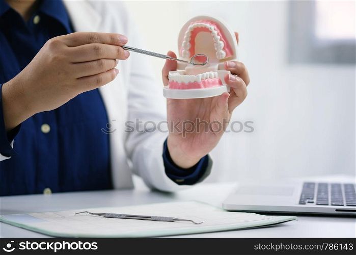 Dentist examining a patient teeth medical treatment at the dental office.
