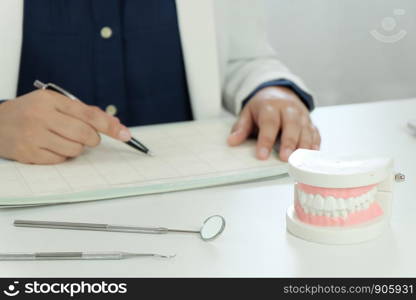 Dentist examining a patient teeth medical treatment at the dental office.