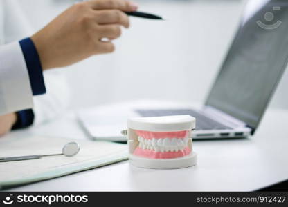 Dentist examining a patient teeth medical treatment at the dental office.