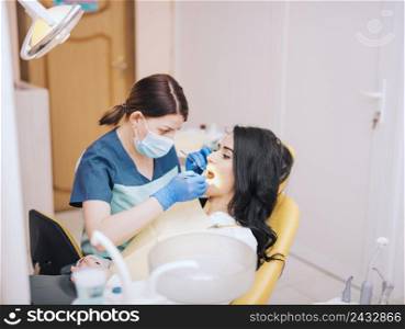 dentist examining patients teeth clinic
