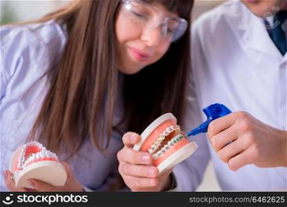 Dentist explaining brackets ligature setting