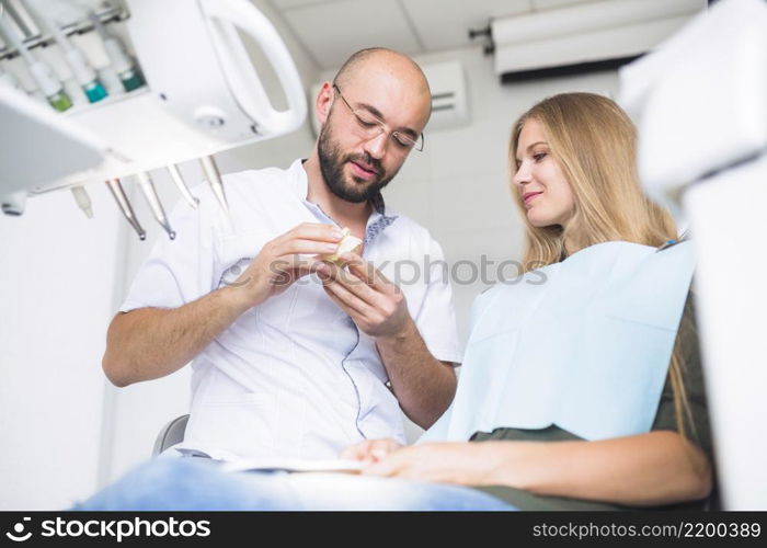 dentist explaining dental hygiene female patient