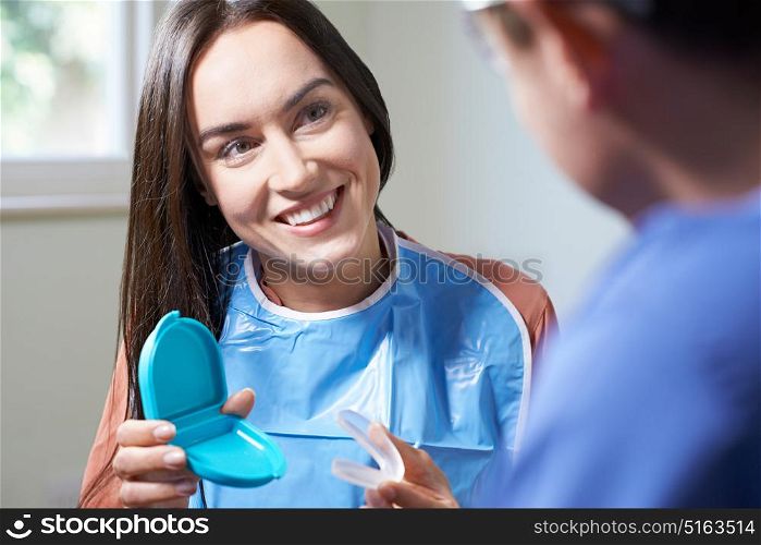 Dentist Giving Woman Advice On Cosmetic Teeth Whitening