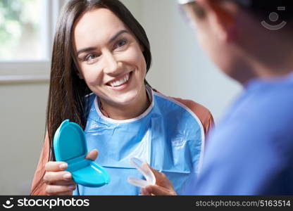 Dentist Giving Woman Advice On Cosmetic Teeth Whitening