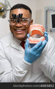 Dentist holding false teeth