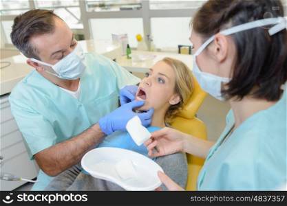 Dentist inspecting female patient