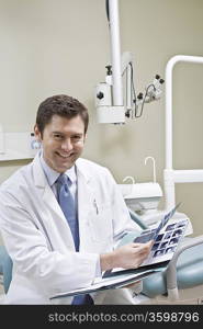 Dentist leafing through medical record