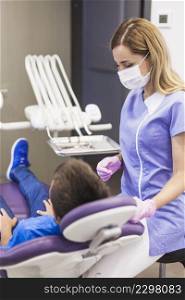dentist looking child patient leaning dental chair