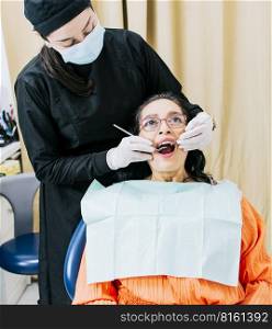 Dentist performing dental checkup, Patient checked by dentist, close up of dentist with patient, dentist performing root canal treatment on patient