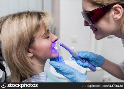 dentist performing teeth whitening