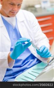 Dentist prepare dental drill tool equipment in stomatology office