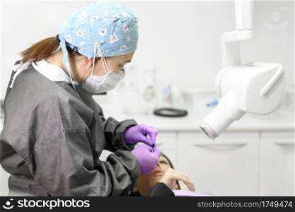 Dentist preparing patient for x-ray diagnostics. High quality photo. Dentist preparing patient for x-ray diagnostics.