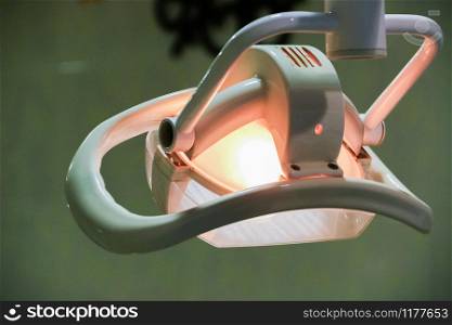 Dentist&rsquo;s office. Shadowless lamp hanging over the dental chair. Equipment for the dental office.. Dentist&rsquo;s office. Shadowless lamp hanging over the dental chair. Equipment for the dental office