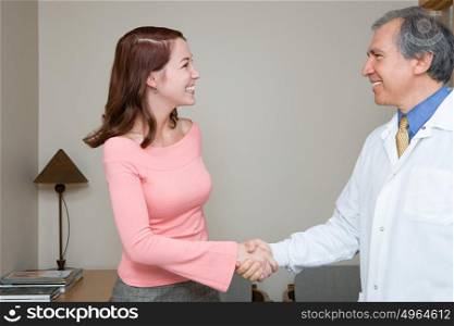 Dentist shaking hands with patient