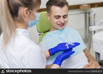dentist showing invisible retainers patient
