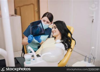dentist showing teeth x ray patient
