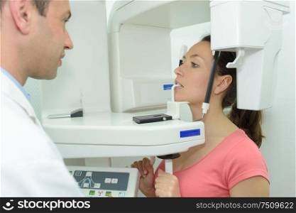 dentist taking patients teeth radiography