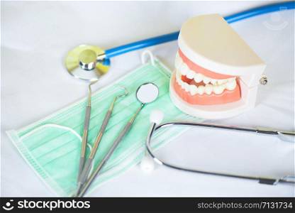 dentist tools with bamboo toothbrush dentures dentistry instruments and dental hygienist checkup concept with teeth model and mouth mirror oral health , selective focus
