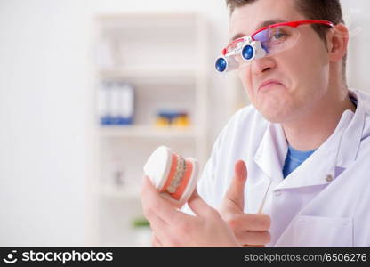 Dentist working teeth implant in medical lab