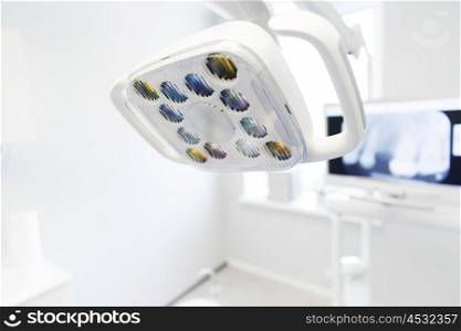 dentistry, medicine, medical equipment and stomatology concept - close up of lamp at dental clinic office