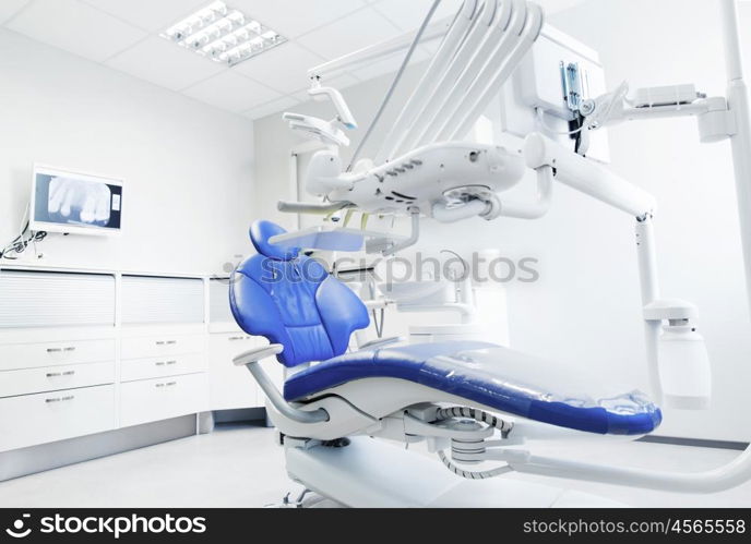 dentistry, medicine, medical equipment and stomatology concept - interior of new modern dental clinic office with chair