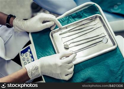 Dentists choose equipment on the table.
