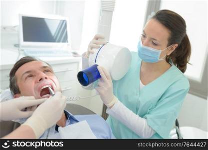 dentists doing an x-ray scan dental clinic office