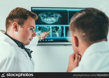 Dentists Having a Conversation over Patient X-Rays