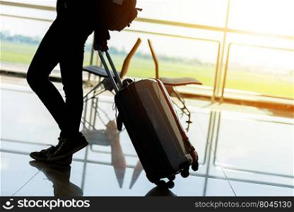 Departure lounge at the airport with traveller and luggage