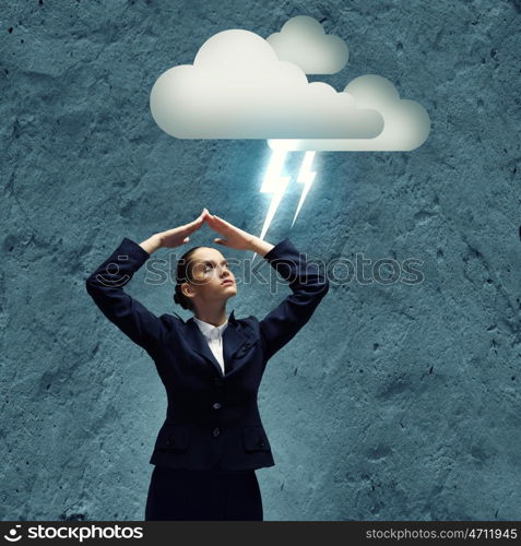 Depressed businesswoman. Young crying businesswoman with arms covering head from rain