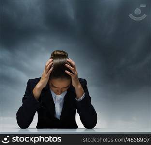 Depressed businesswoman. Young crying businesswoman with hands on head