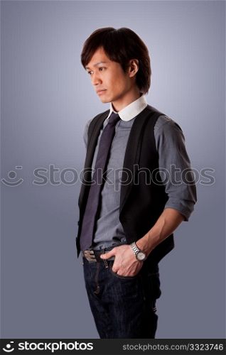Depressed casual Asian business man with sad look, side view, wearing jeans and dress shirt with tie, isolated.