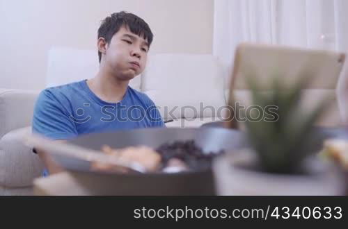 Depressed desperate man feeling worried about financial problem, casual style man sighing while looking at his wallet with no money in there, frustrated thinking of money debt, broke asian man