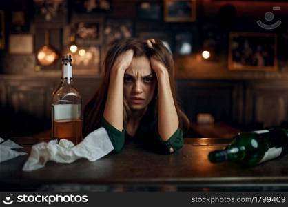 Depressed drunk woman in bar, stress relief. One female person in pub, human emotions, leisure activities, depression. Depressed drunk woman in bar, stress relief