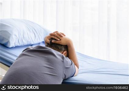 Depressed elderly spouse man mourning on patient bed for gone wife in hospital room