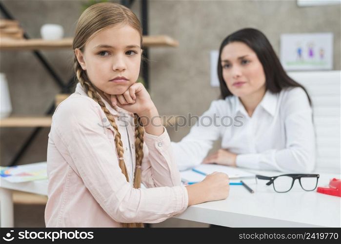 depressed girl sitting front her female psychologist
