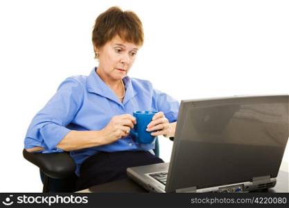 Depressed looking businesswoman staring at her computer. Isolated on white.