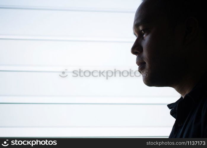 depressed man Absent-minded stand edge the window .dramatic concept