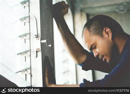 depressed man Absent-minded stand edge the window .dramatic concept