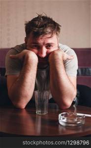 Depressed man after hard drinking. Alcohol abuse problem concept.