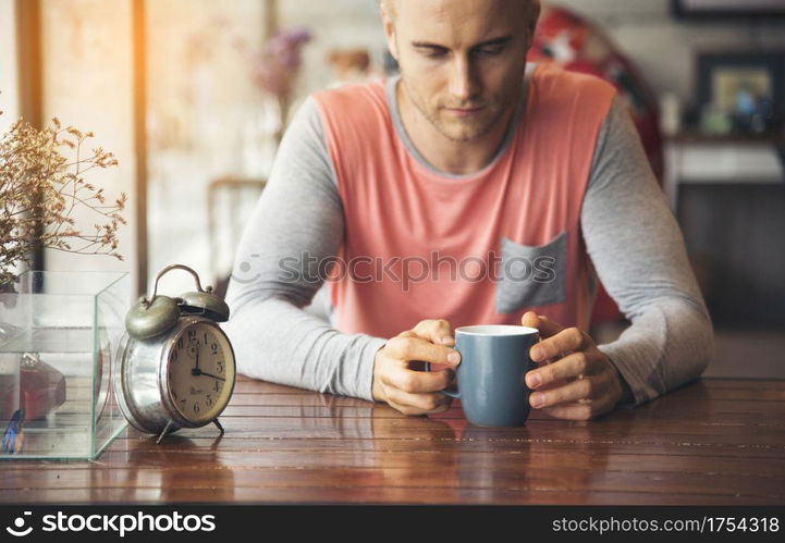 Depressed man awake until the morning can?t sleep, Anxiety adult is exhausted and suffering from insomnia panic disorder. Caffeine from coffee can boot more energy in morning. Man Lifestyle Concept