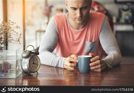 Depressed man awake until the morning can?t sleep, Anxiety adult is exhausted and suffering from insomnia panic disorder. Caffeine from coffee can boot more energy in morning. Man Lifestyle Concept