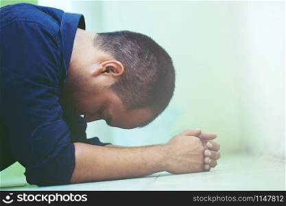 depressed man bent head in hands go with floor. dramatic concept