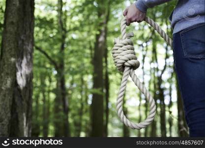 Depressed Man Contemplating Suicide By Hanging In Forest