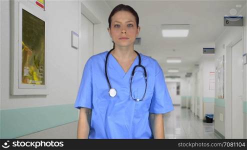 Depressed nurse crosses her arms while in the hall